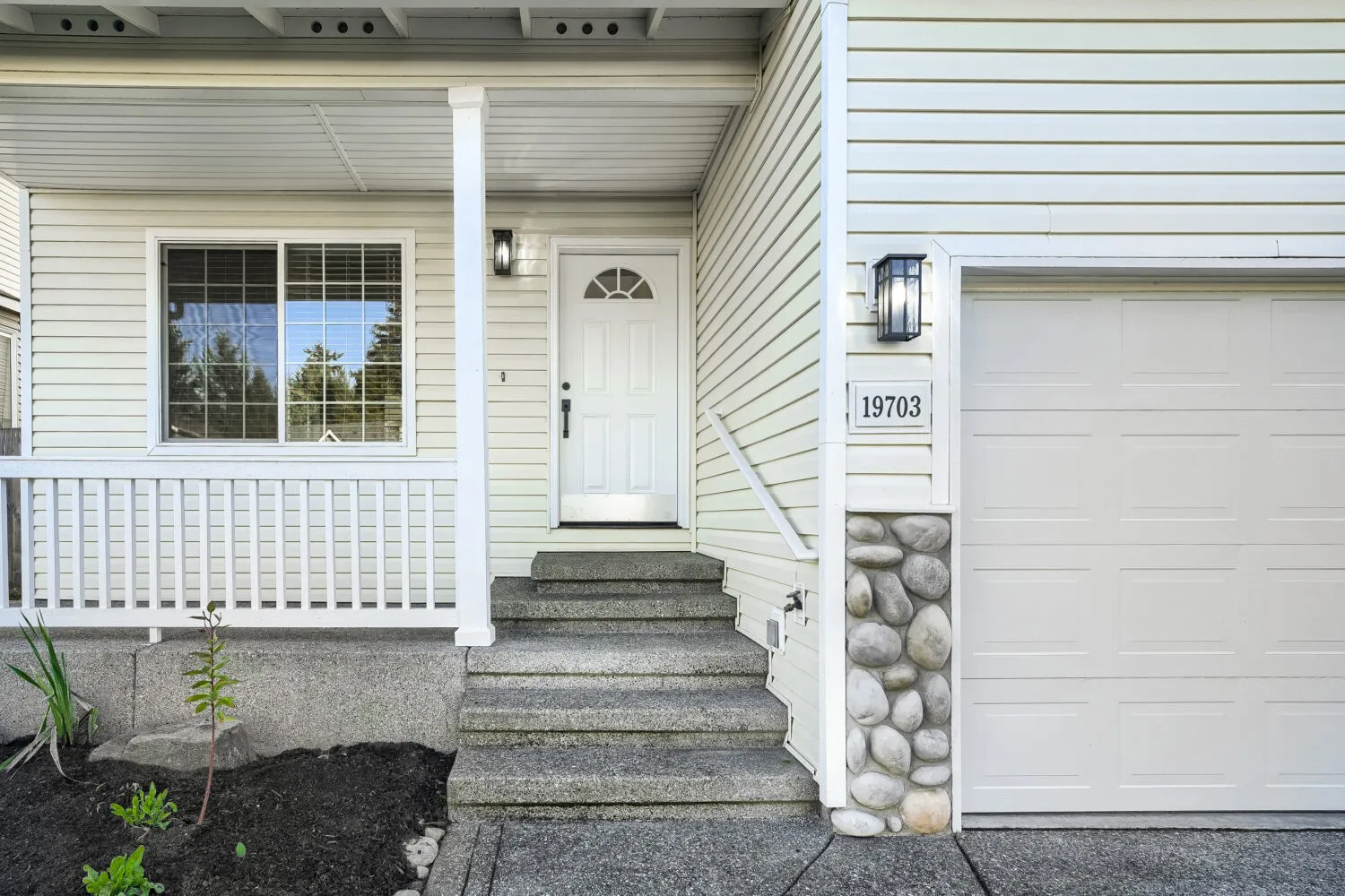 Covered front porch and entry with stone column base