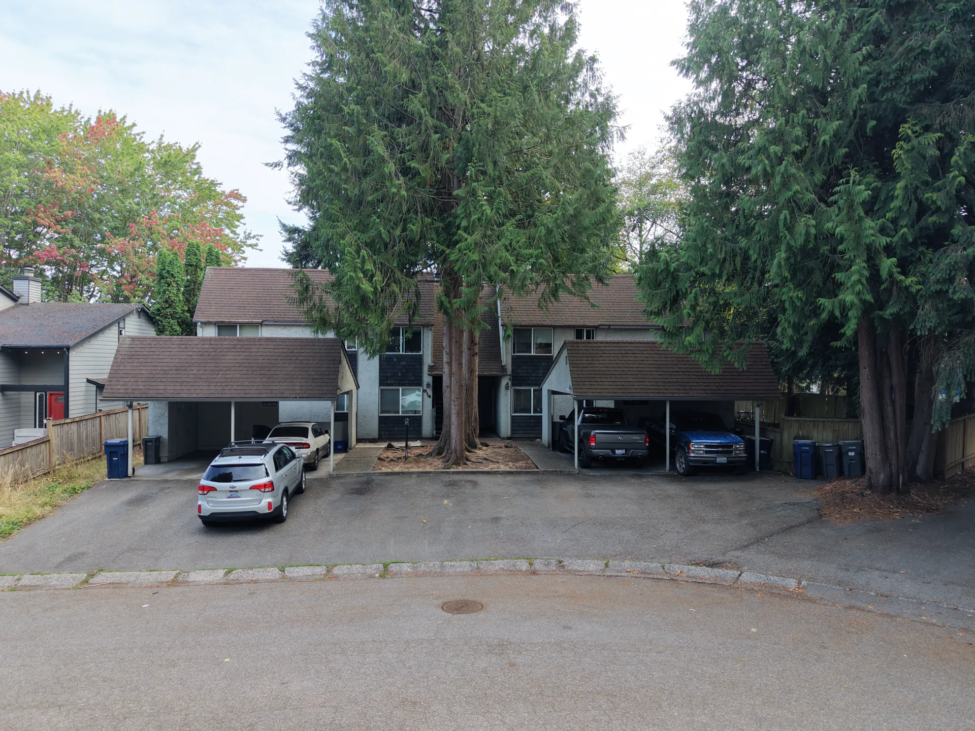 Front elevation of the fourplex with covered carports on both sides